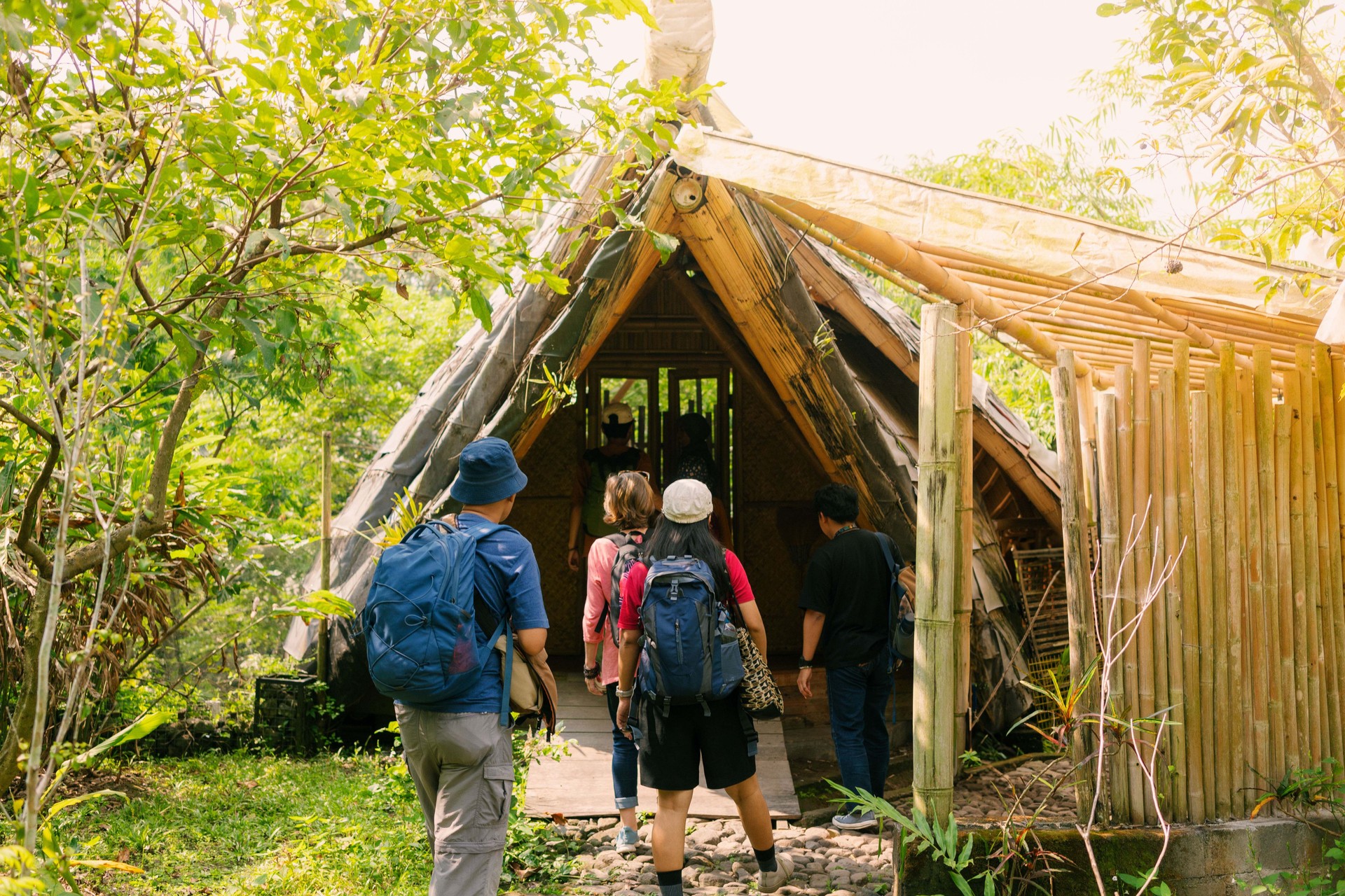 Female Muslim Bamboo Villa Owner Showing Guest Their Room